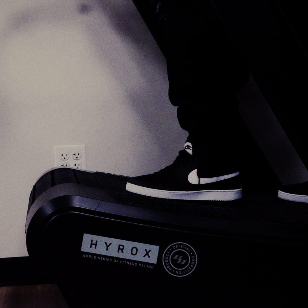 Trainer running on a HYROX curved treadmill at The Den