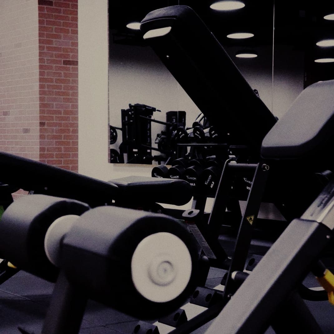 Adjustable benches and free weights on The Den training floor