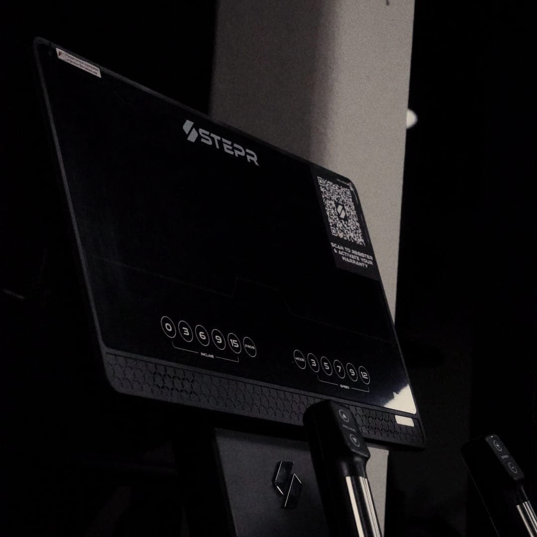 STEPR cardio machine display in a low-lit training room